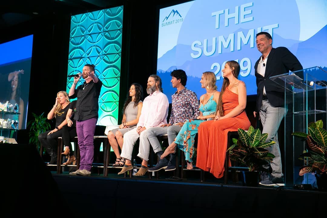 Tala Sage hosting a panel on stage at a company summit