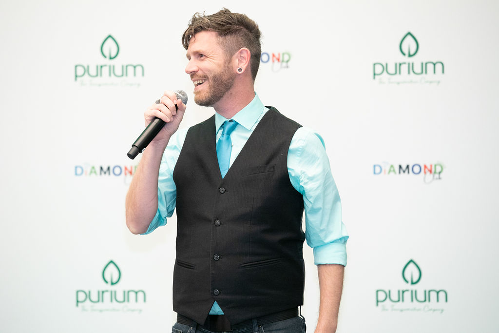 Tala Sage speaking in front of a Purium step and repeat