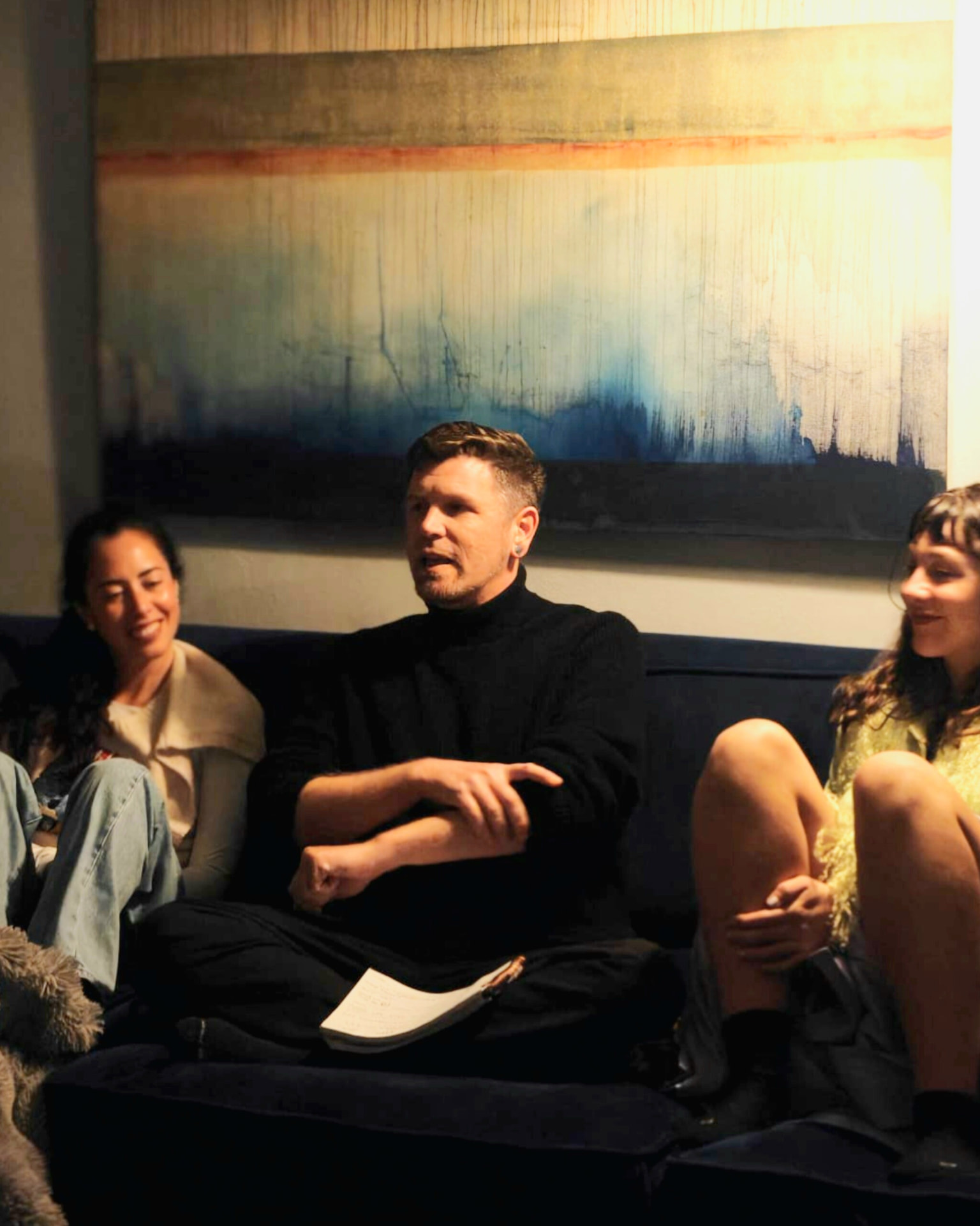 Tala Sage facilitating a panel conversation with a seated audience