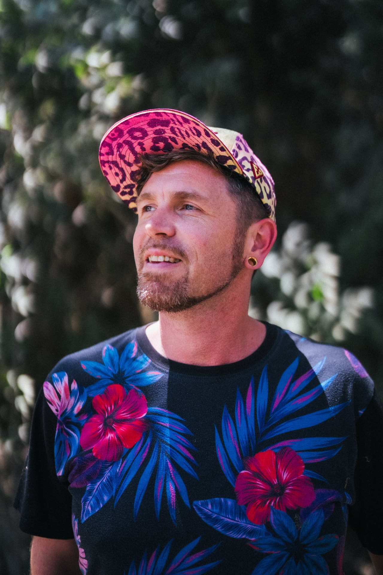 Tala Sage outdoors in a colorful floral shirt and patterned cap